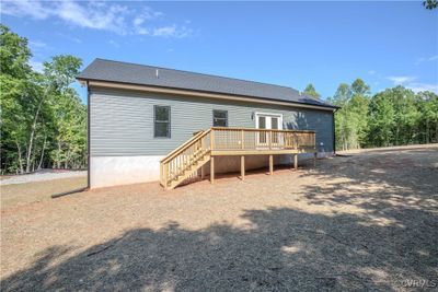 The back of the home features a large deck. | Image 2