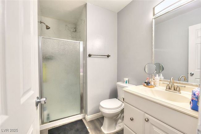 Bathroom with a shower stall, vanity, and laminate finished floors | Image 14