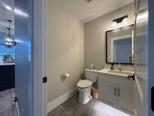 Bathroom with baseboards, vanity, and toilet | Image 31