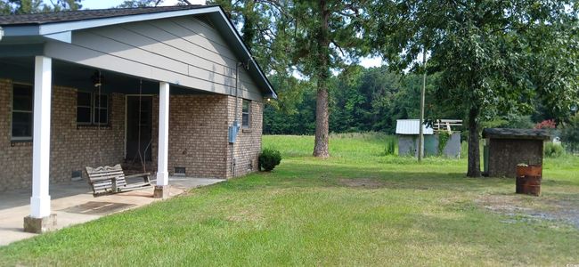 View of grassy yard with a patio | Image 10
