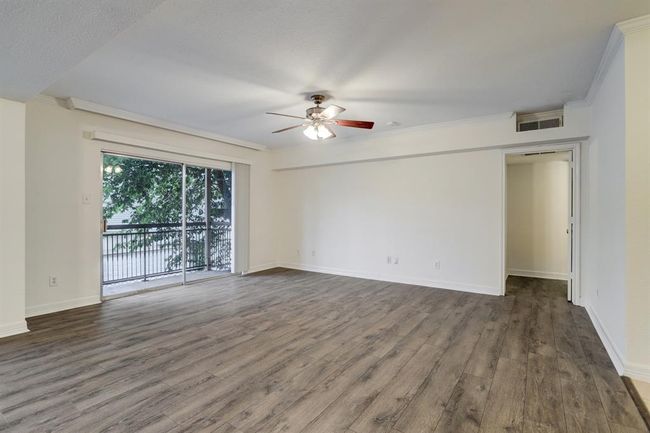 A view of the living room facing one of the bedrooms. The room is so spacious that you should not have any trouble fitting your furniture! | Image 10