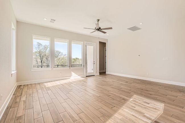 Unfurnished room with light wood finished floors, a ceiling fan, and visible vents | Image 9