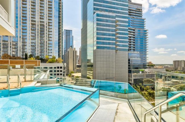 Community pool featuring a patio, pingpong tables, entertainment area for watching sports by the pool | Image 22