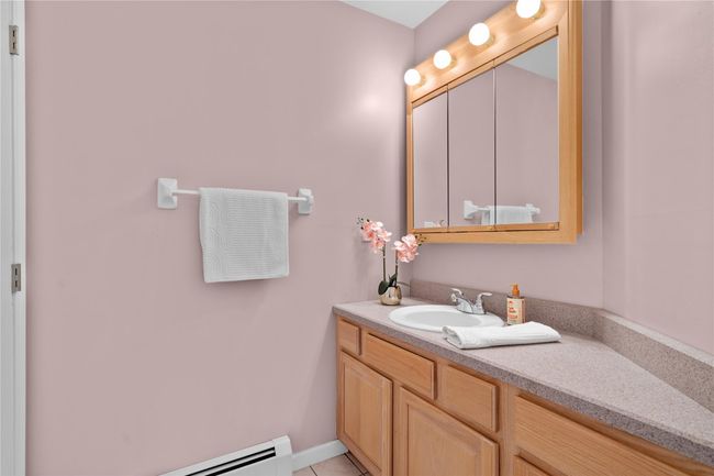 Bathroom featuring vanity, tile patterned flooring, and baseboard heating | Image 23