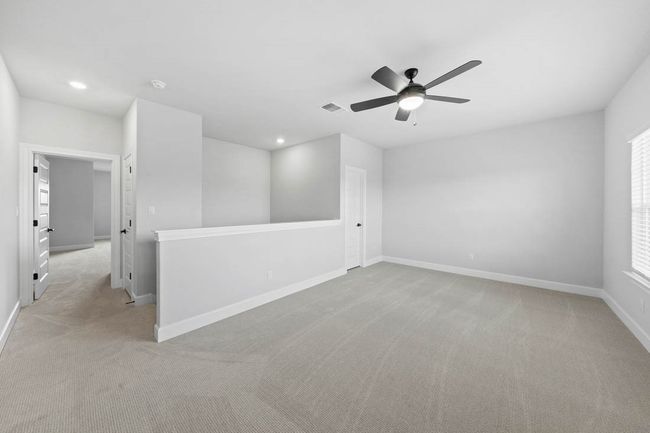 Stairs lead to spacious game room that also includes a generously sized closet for storage. | Image 6