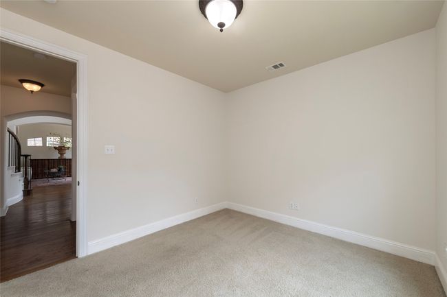 Carpeted empty room with arched walkways and baseboards | Image 37