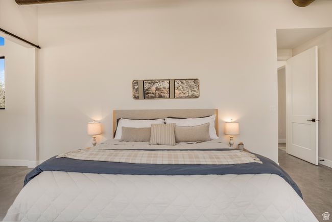Bedroom featuring finished concrete floors and baseboards | Image 21
