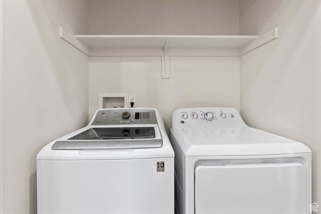 Laundry area featuring washing machine and dryer | Image 14