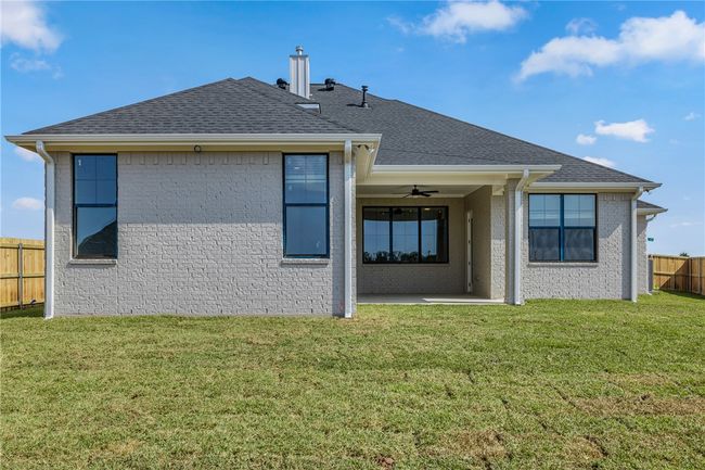 Rear view of property with a yard and ceiling fan | Image 33