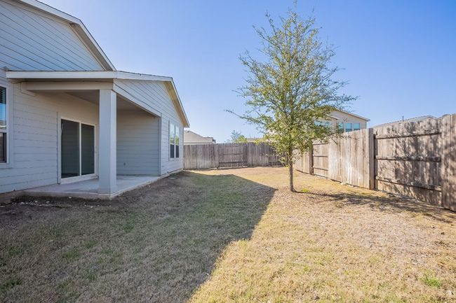 View of yard with a fenced backyard and a patio | Image 34