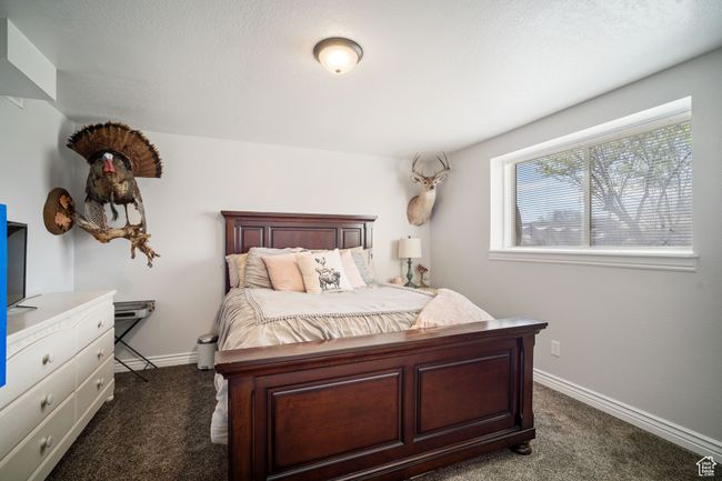 Bedroom with dark carpet and baseboards | Image 15