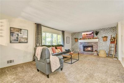 Living room with light carpet and a fireplace | Image 3