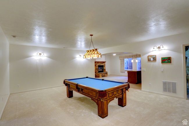 Recreation room featuring light carpet, visible vents, baseboards, and billiards | Image 31