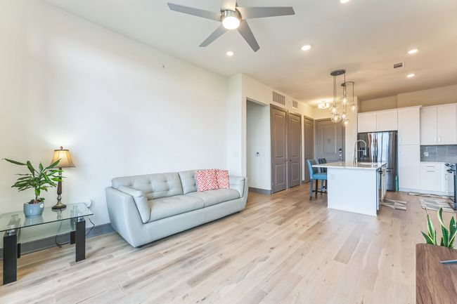 Living area featuring light wood-style flooring, recessed lighting, and a ceiling fan | Image 6