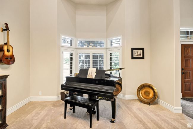 Living area featuring carpet and a high ceiling | Image 26
