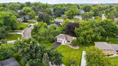 Home is perfectly positioned on the lot newly asphalted streets and curbed sidewalks, easy access to Melody Lake Park and lakeside benches. | Image 3