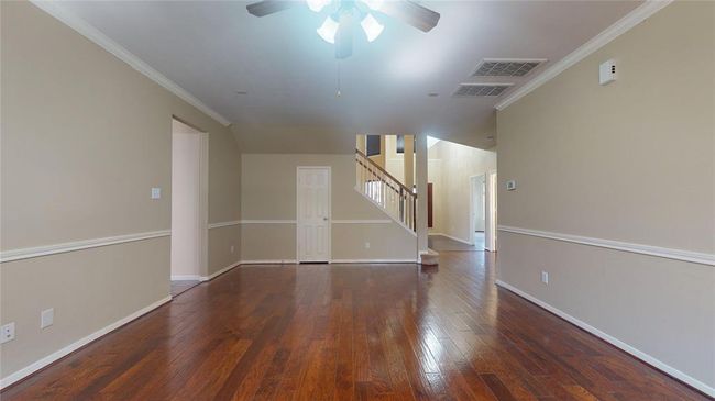 Spacious family room with convenient under-stair storage. | Image 17