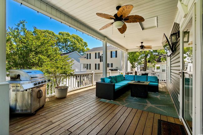 Deck featuring a porch, outdoor lounge area, and outdoor dining area | Image 11
