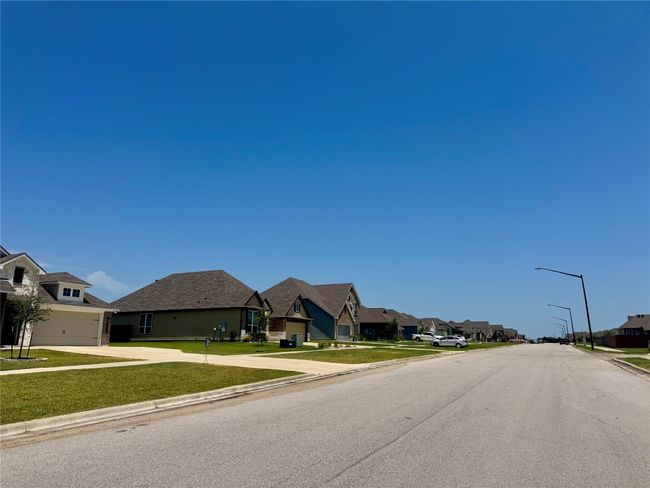 View of WIDE ROAD featuring street lights, sidewalks, curbs. | Image 22