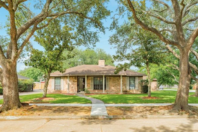 One story custom built brick ranch on a large corner lot, centrally located in the desirable Pearland community. The canopies from the tall trees provide shade from our Texas sun. Sit an relax with your favorite beverage on the expansive porch. | Image 32