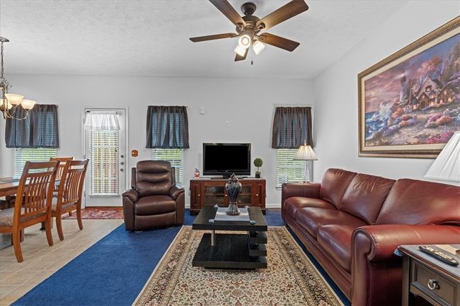 Open flow between the family room and kitchen. Large windows provide tons of light. | Image 11