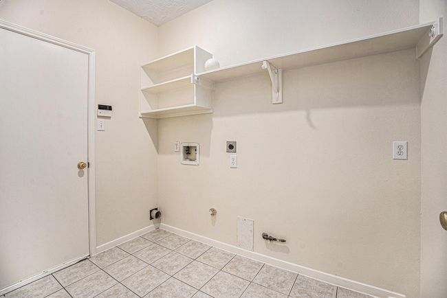 Indoor laundry leading to garage. | Image 28
