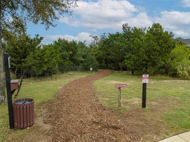 View of community featuring a yard and fence | Image 32