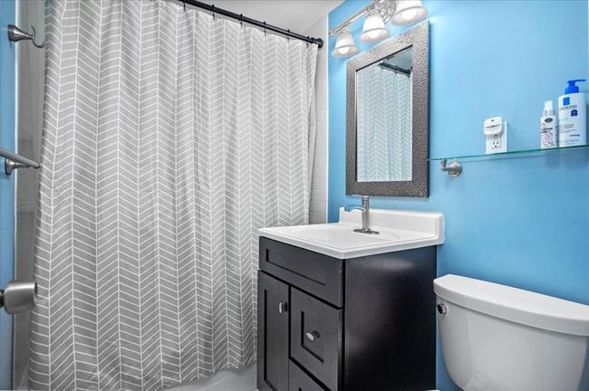 Full bathroom with vanity and curtained shower | Image 20