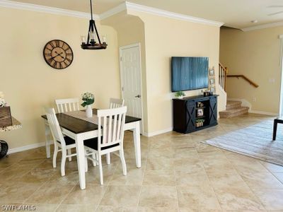 Tiled dining space with a notable chandelier and ornamental molding | Image 3