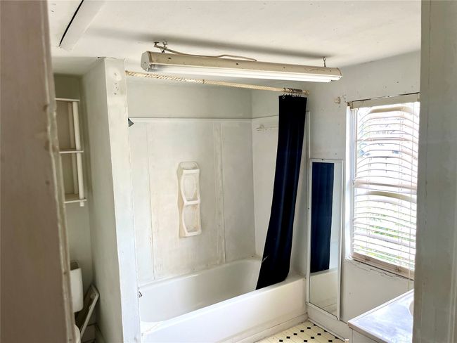 Full bath with healthy amount of natural light and shower / bathtub combination with curtain | Image 6