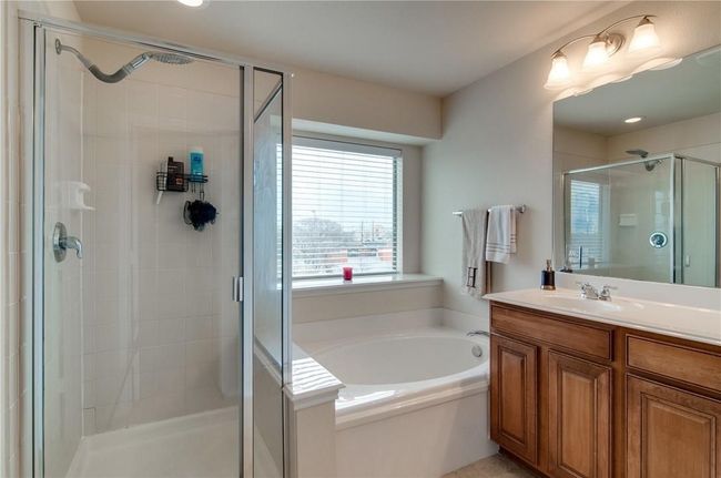 Bathroom featuring vanity and separate shower and tub | Image 13
