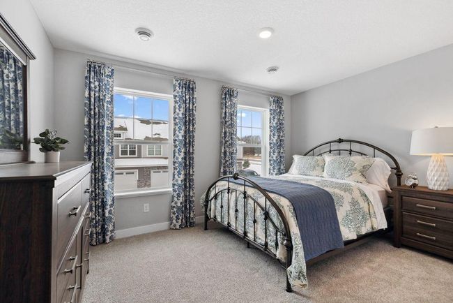 Tucked away from the hustle and bustle of the main level living spaces, this bedroom resides adjacent to a full bath and serves as the perfect guest room or your home office! Photo is of model home. | Image 31