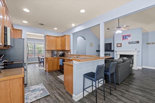 Kitchen featuring dark wood-type flooring, and arched walkways | Image 12