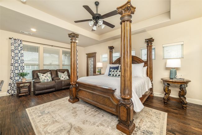 Bedroom featuring baseboards, multiple windows, decorative columns, wood finished floors, and recessed lighting | Image 16
