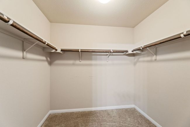 Spacious closet with carpet flooring | Image 9