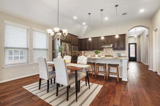 Dining area looking into the kitchen and foyer hallway | Image 4