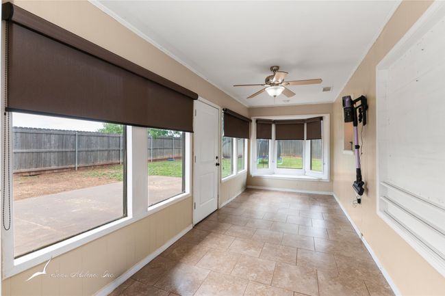 Unfurnished sunroom with baseboards and ornamental molding | Image 25