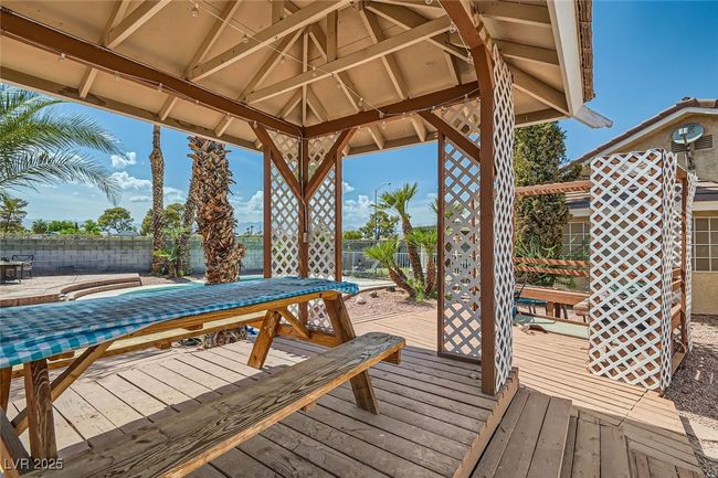 Wooden terrace with outdoor dining area and fence | Image 27