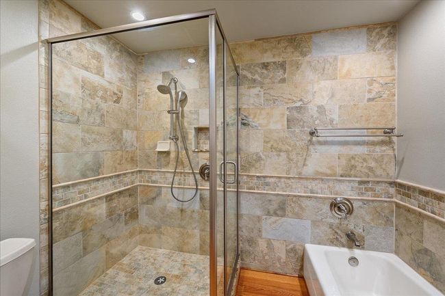 Main bathroom tiled shower stall and soaking tub | Image 39