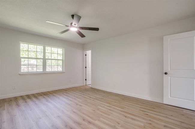 Unfurnished room with light wood-style flooring and a ceiling fan | Image 22