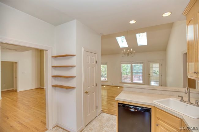 Kitchen featuring a sink, recessed lighting, light wood-style floors, black dishwasher, and light countertops | Image 12