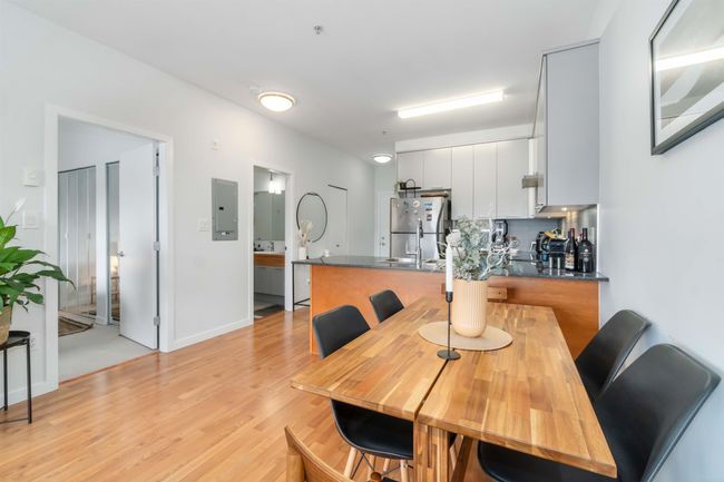 Dining space featuring light wood-style flooring and electric panel | Image 13