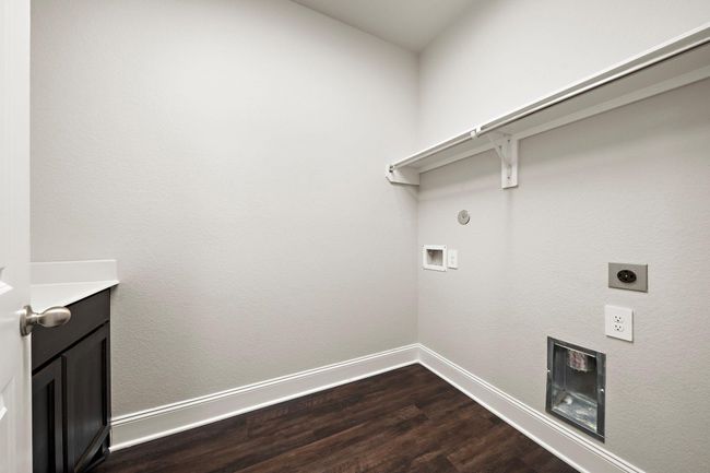 Laundry room located on the first floor features a counter top and cabinets that are a great addition to the laundry area. | Image 25