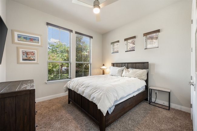 Bedroom featuring multiple windows, carpet, and a ceiling fan | Image 21