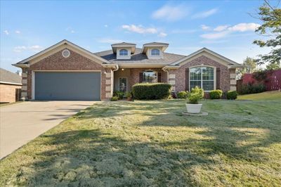 View of front of property with a garage and a front lawn | Image 1