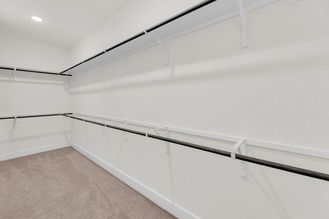 Spacious closet with light carpet | Image 23