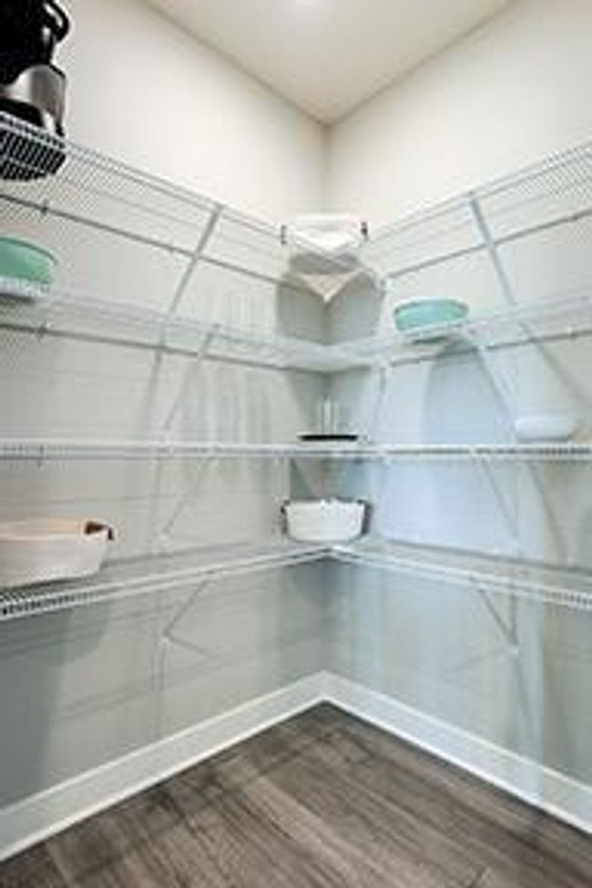 An amazingly spacious corner walk-in pantry for all of your culinary storage needs. Photo of model home, colors and selections shown may vary | Image 7