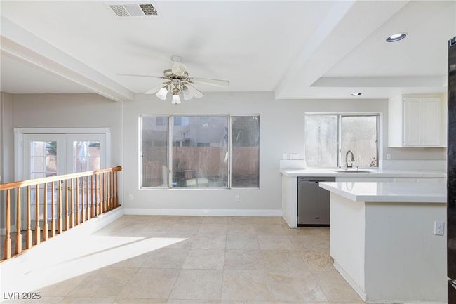 Kitchen featuring a ceiling fan, visible vents, dishwasher, light countertops, and a sink | Image 12
