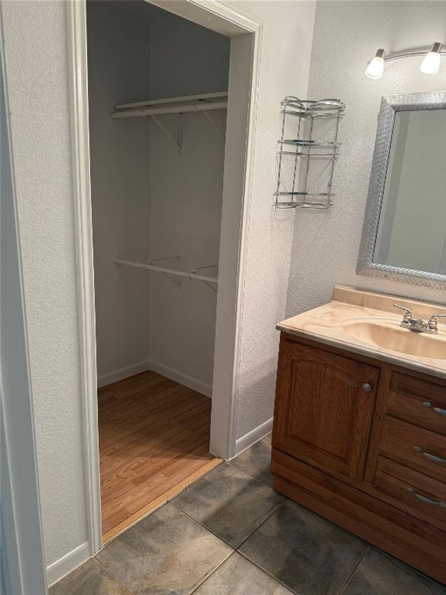 Bathroom with vanity, a spacious closet, and tile patterned flooring | Image 10