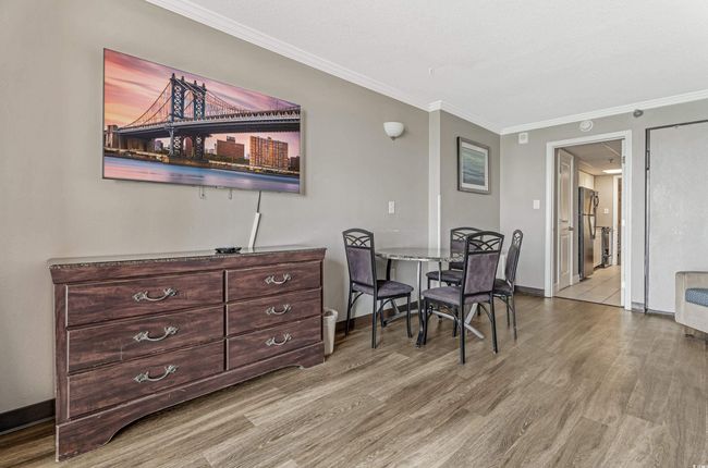 Dining room featuring wood finished floors and ornamental molding | Image 12